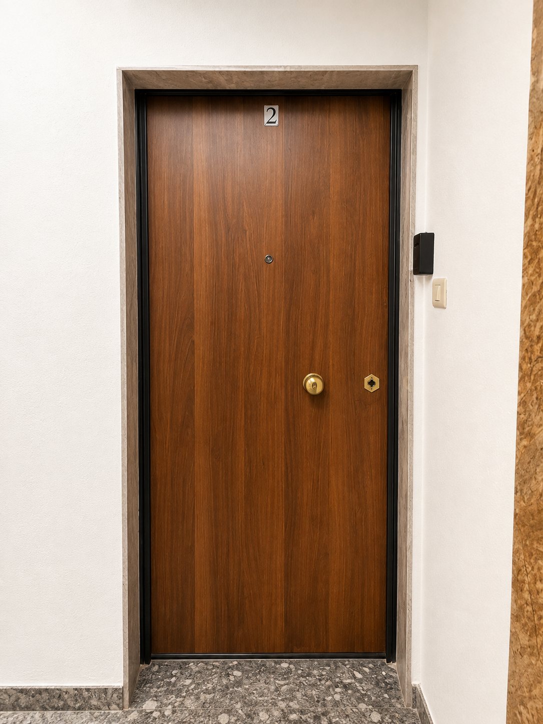 The apartment door on the first floor, with the lockbox mounted on the wall to its right