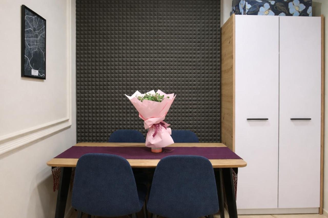 Dining table set with flowers beside the wardrobe at The Prism apartment